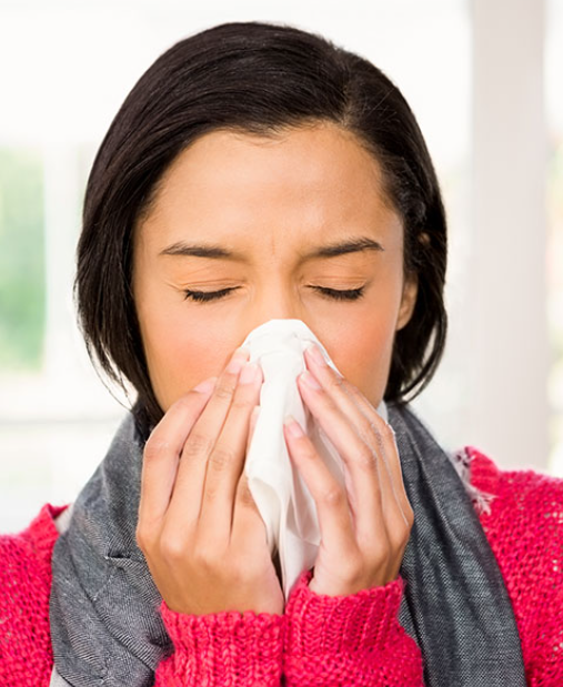 woman blowing her nose